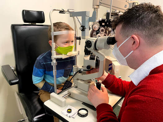 Patient Henry is given an eye exam by Dr.Nick Paradis at Wild Apple Eye Care in Centerbrook, Connecticut